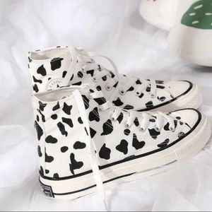 Cow print high top converse